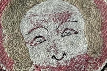 Opus anglicanum - an example of a face stitched in fine directional split stitch.