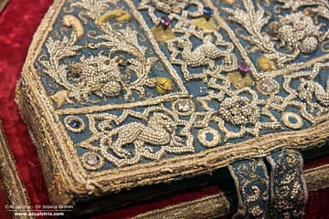 Pearl Embroidery - a blue pearl-embroidered mitre on display in a museum.