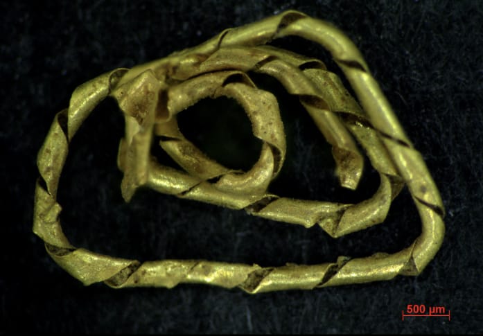 Gold threads -gold threads parts on a black background