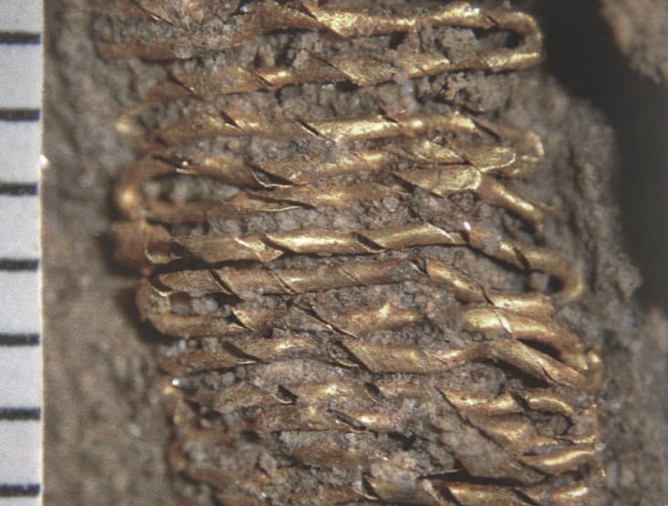 Gold threads - twisted gold threads in the dirt