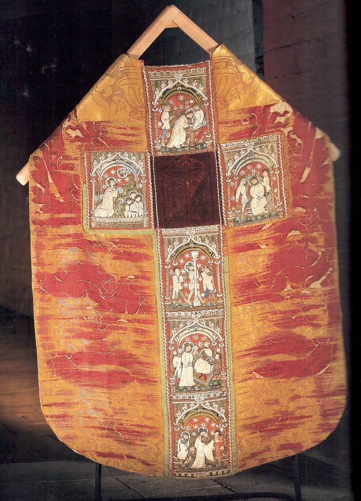 Medieval Goldwork - red chasuble with multi coloured embroidery on a wooden stand